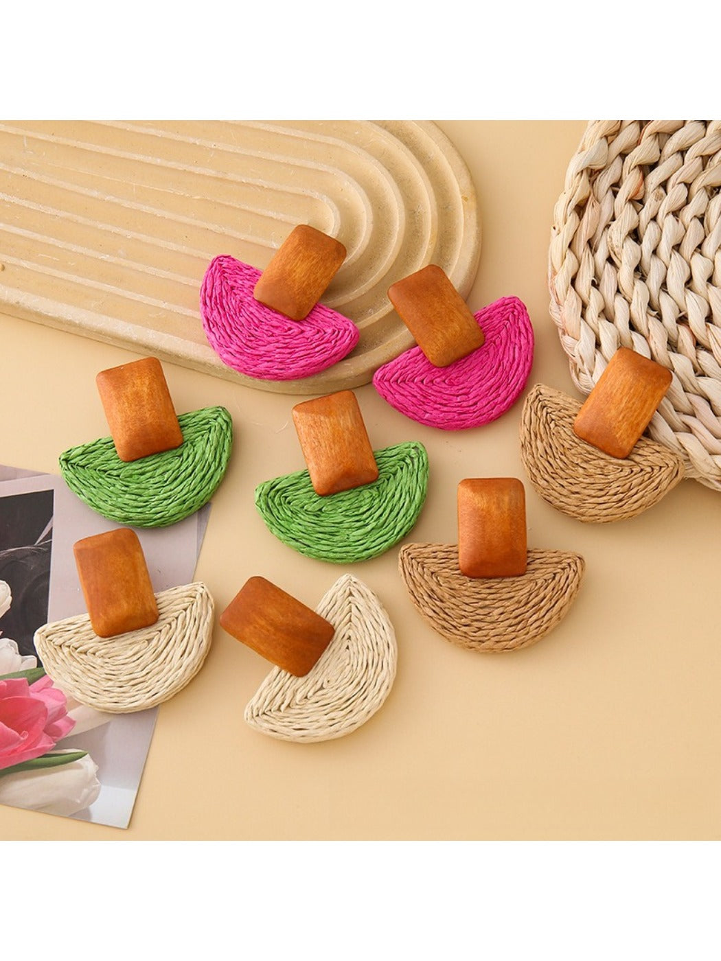 Close-up of Earedge raffia mushroom shaped stud earrings on white background