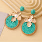 Detailed shot of Earedge circular floral drop earrings showing craftsmanship and texture