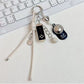 Baseball cap shaped keychain in red with white stitching and silver key ring
