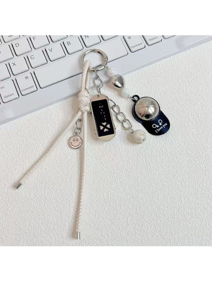 Baseball cap shaped keychain in red with white stitching and silver key ring
