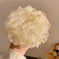 Gifty vintage scrunchie styled in hair, featuring bead accents and soft fabric