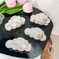 Beau elegant cloud shaped hair claw clip in white on a plain background
