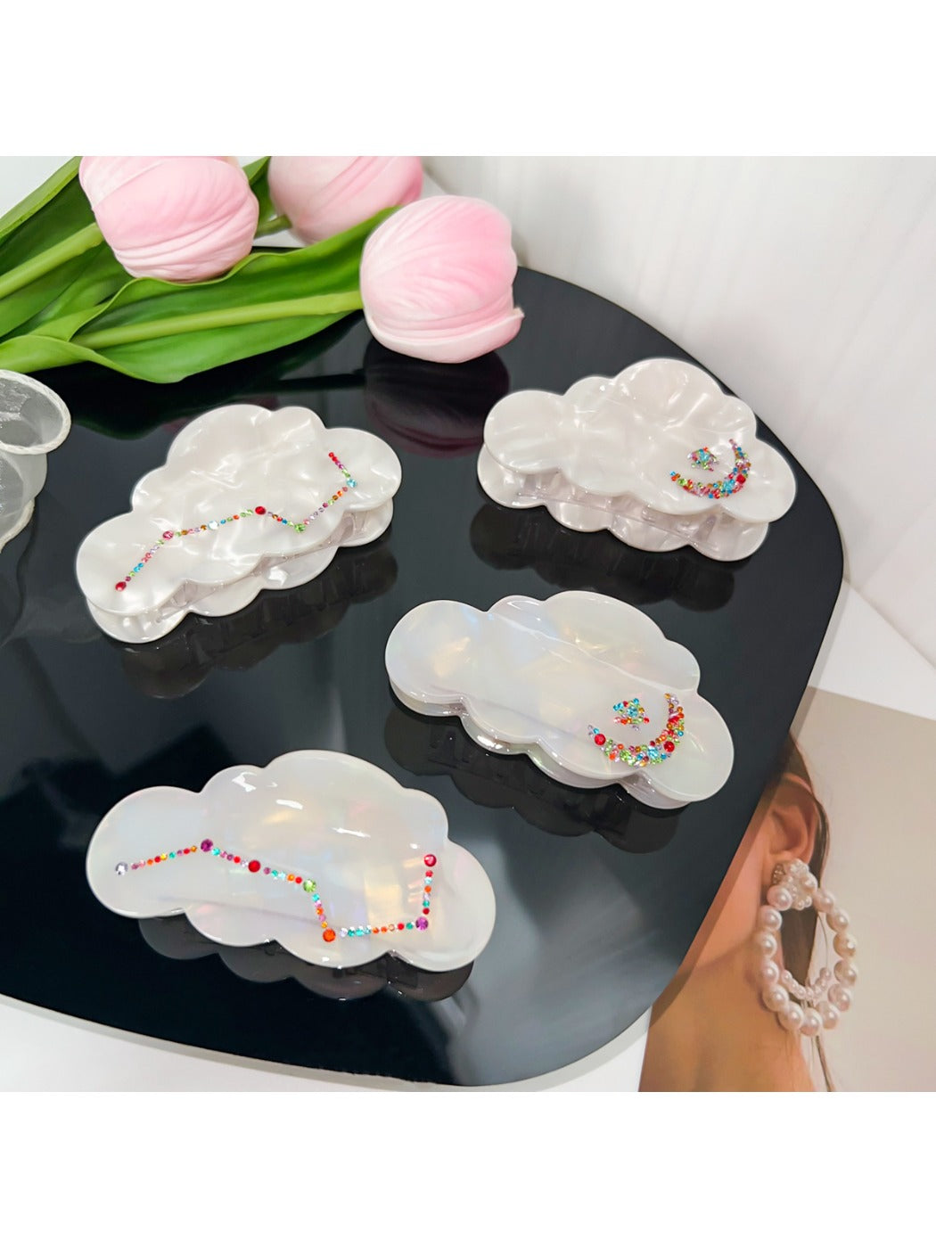 Beau elegant cloud shaped hair claw clip in white on a plain background