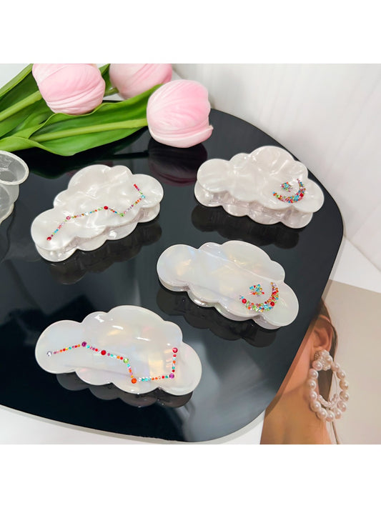 Beau elegant cloud shaped hair claw clip in white on a plain background