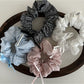 Gifty Sweet Bow Stripe Scrunchie displayed flat showing bow detail and striped pattern
