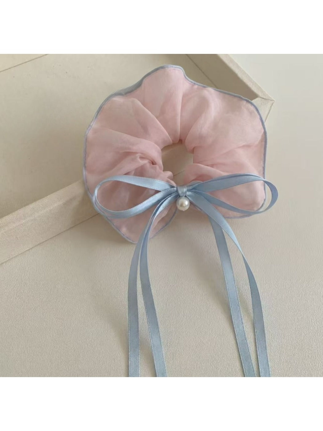 Close-up of Gifty scrunchie showing ruffled texture and bow detail