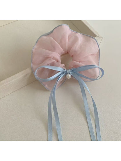 Close-up of Gifty scrunchie showing ruffled texture and bow detail