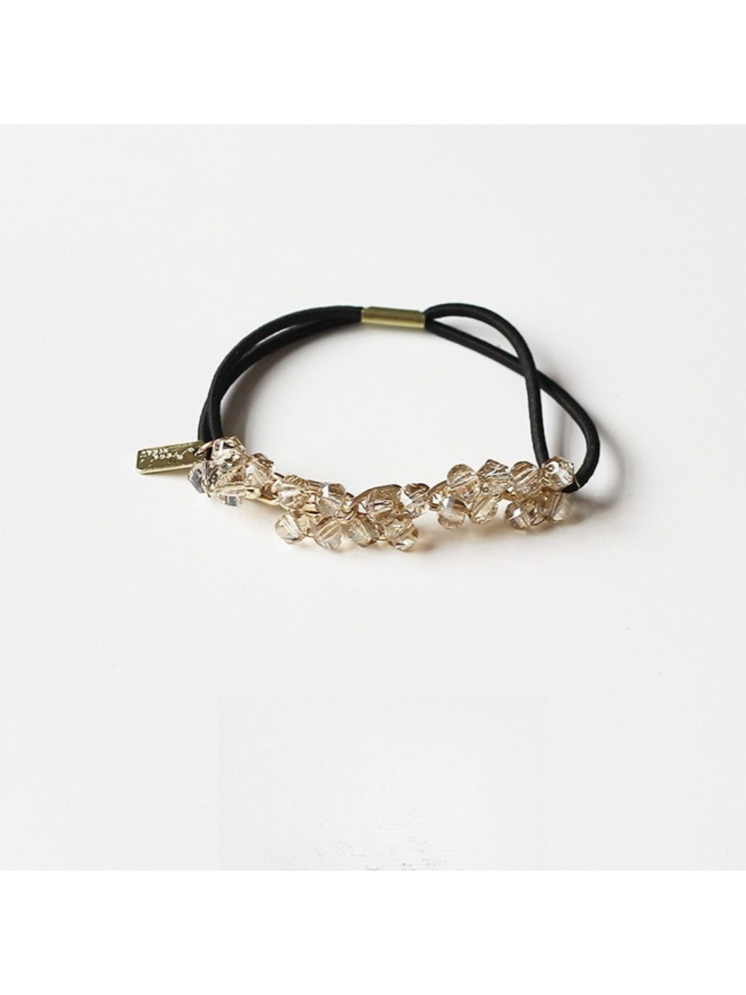 Gifty hair tie placed next to matching accessories on a wooden surface