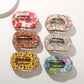 Beau fashionable hair clip with colorful geometric pattern on white background