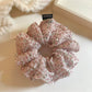 Close-up of pink floral tulle scrunchie showing fabric texture