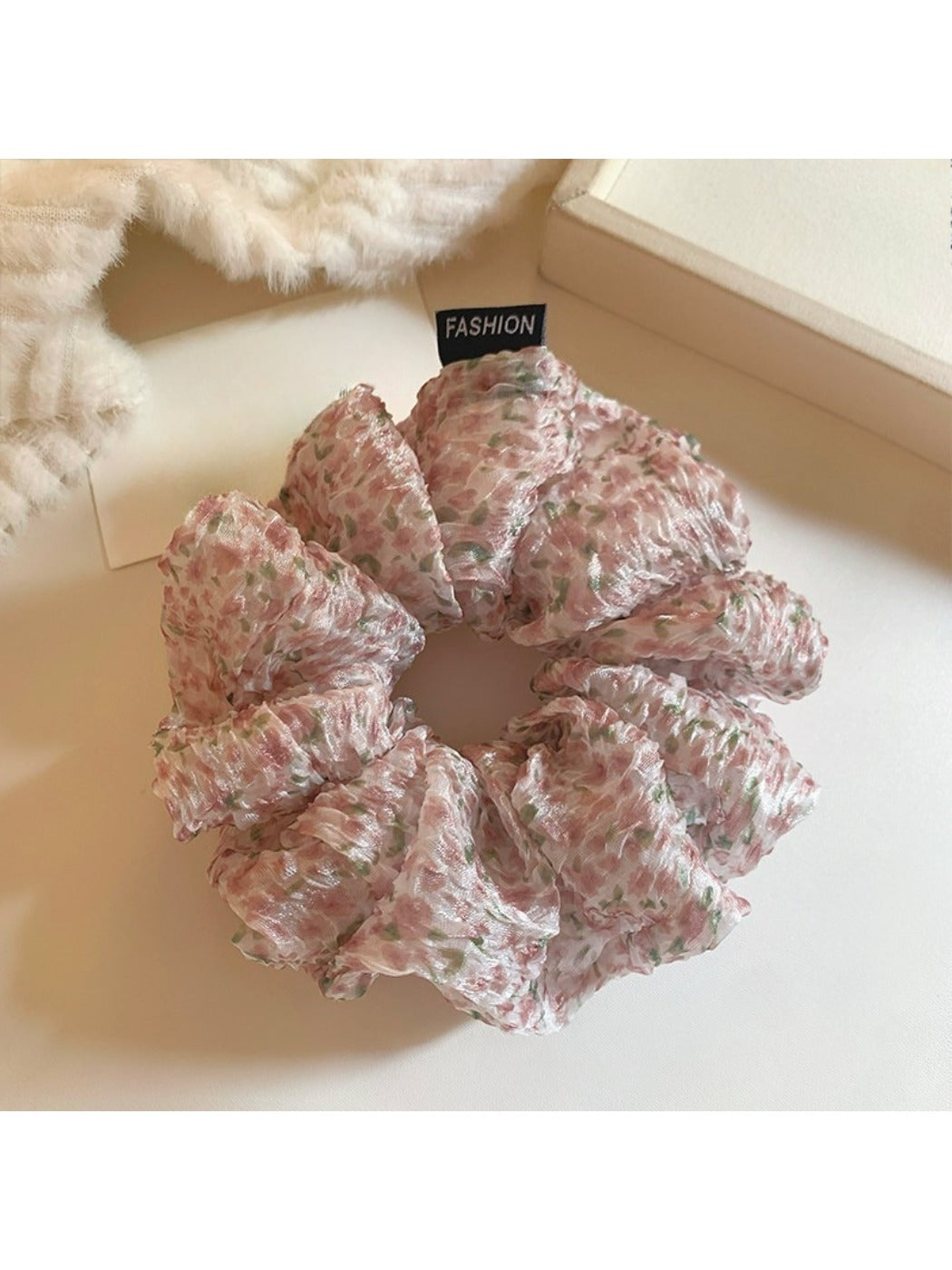 Close-up of pink floral tulle scrunchie showing fabric texture
