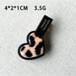 Top view of Beau acrylic hair clip highlighting pink flower and heart design
