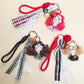 Fabric curly hair doll keychain with smiling face and colorful outfit