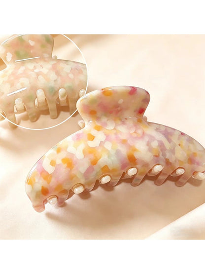 Side angle of Beau chic tiny floral acetate claw clip highlighting clip teeth