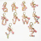 Close-up of delicate butterfly letter pendant on a silver keychain