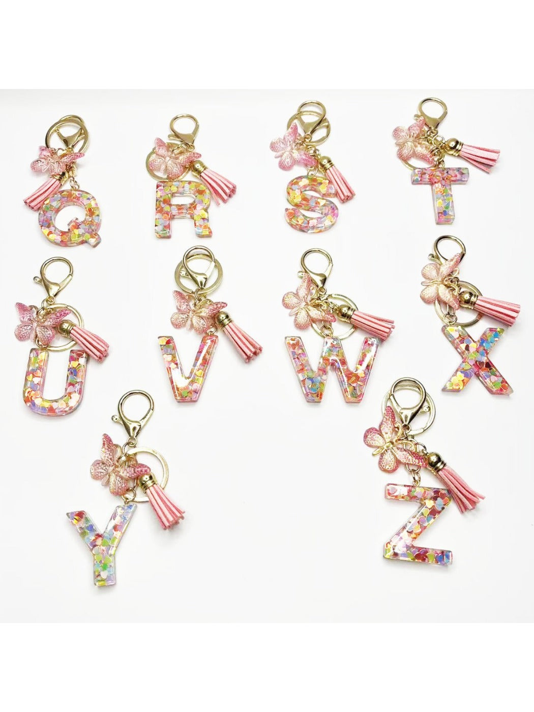 Close-up of delicate butterfly letter pendant on a silver keychain