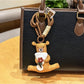 Side view of the bear keychain showing detailed facial features and flower