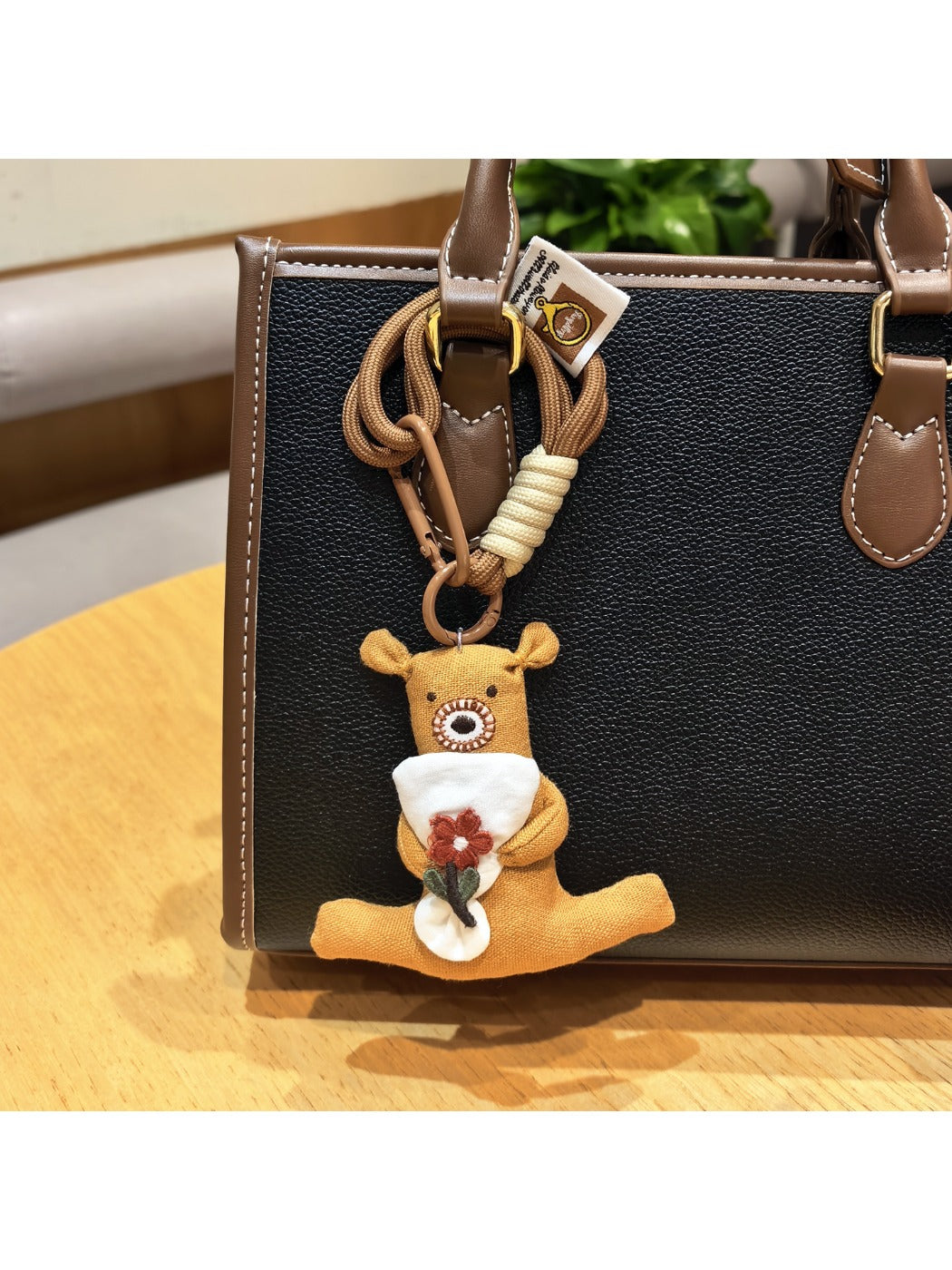 Side view of the bear keychain showing detailed facial features and flower