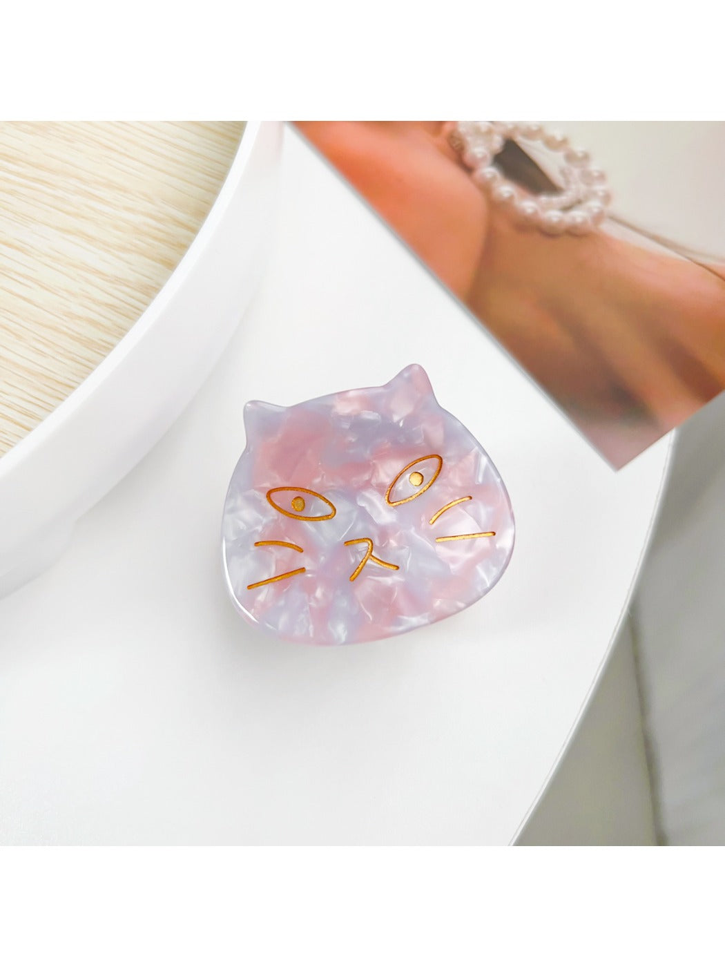 Beau hair claw clip on white background highlighting cat ear design
