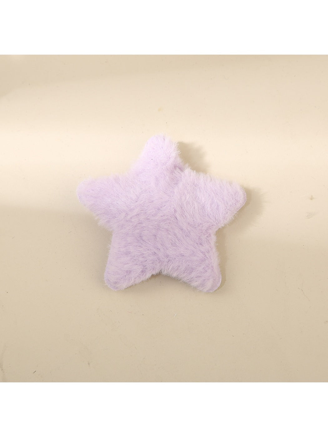 Beau star hair clip placed next to a ruler for size reference