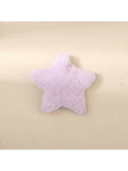 Beau star hair clip placed next to a ruler for size reference