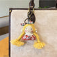 Vintage girl charm keychain photographed against a plain background for clear view