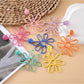 Close-up of Earedge flower shaped openwork drop earring with intricate petal design