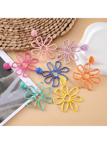 Close-up of Earedge flower shaped openwork drop earring with intricate petal design