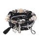 Detailed shot of tassel charm on Lovra vintage stackable beaded bracelet