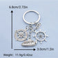 Steamship keychain attached to a keyring on a wooden surface