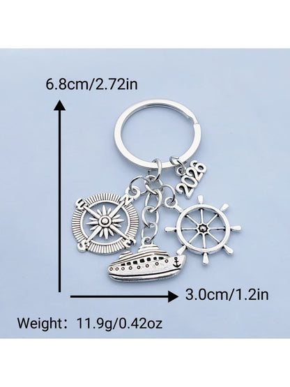 Steamship keychain attached to a keyring on a wooden surface