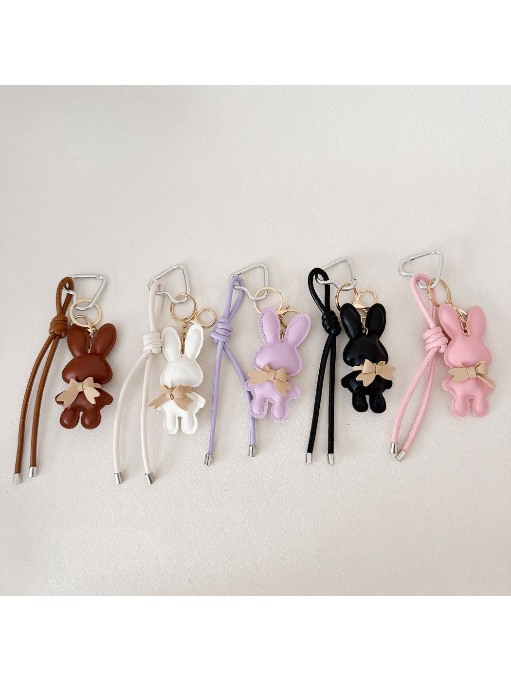 Front view of cartoon little bunny shaped keychain in pastel colors