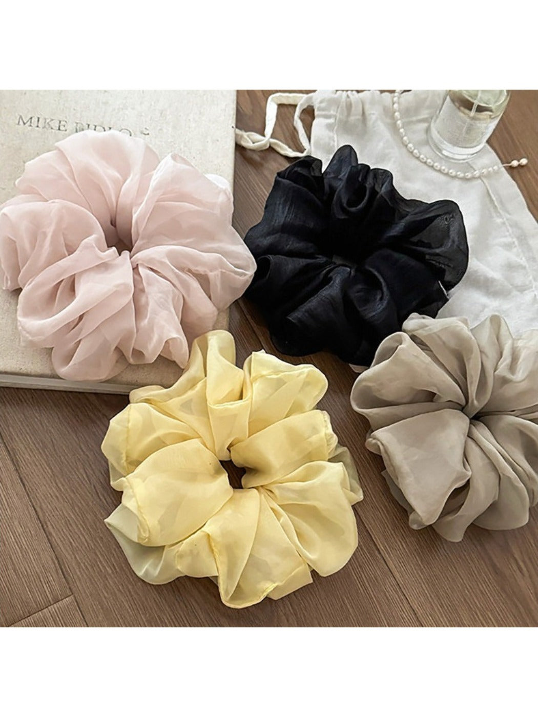 Side view of the ruched scrunchie highlighting its smooth fabric finish