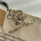 Beau large size claw clip in glossy acetate material with marbled brown tones