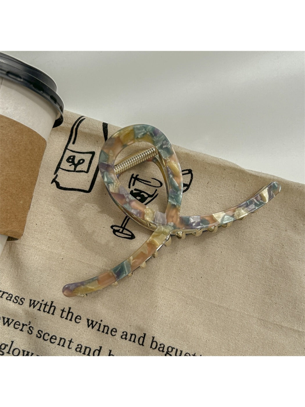 Beau large size claw clip in glossy acetate material with marbled brown tones
