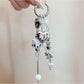 Close-up of Keypus star charm and pink bow on gold keychain