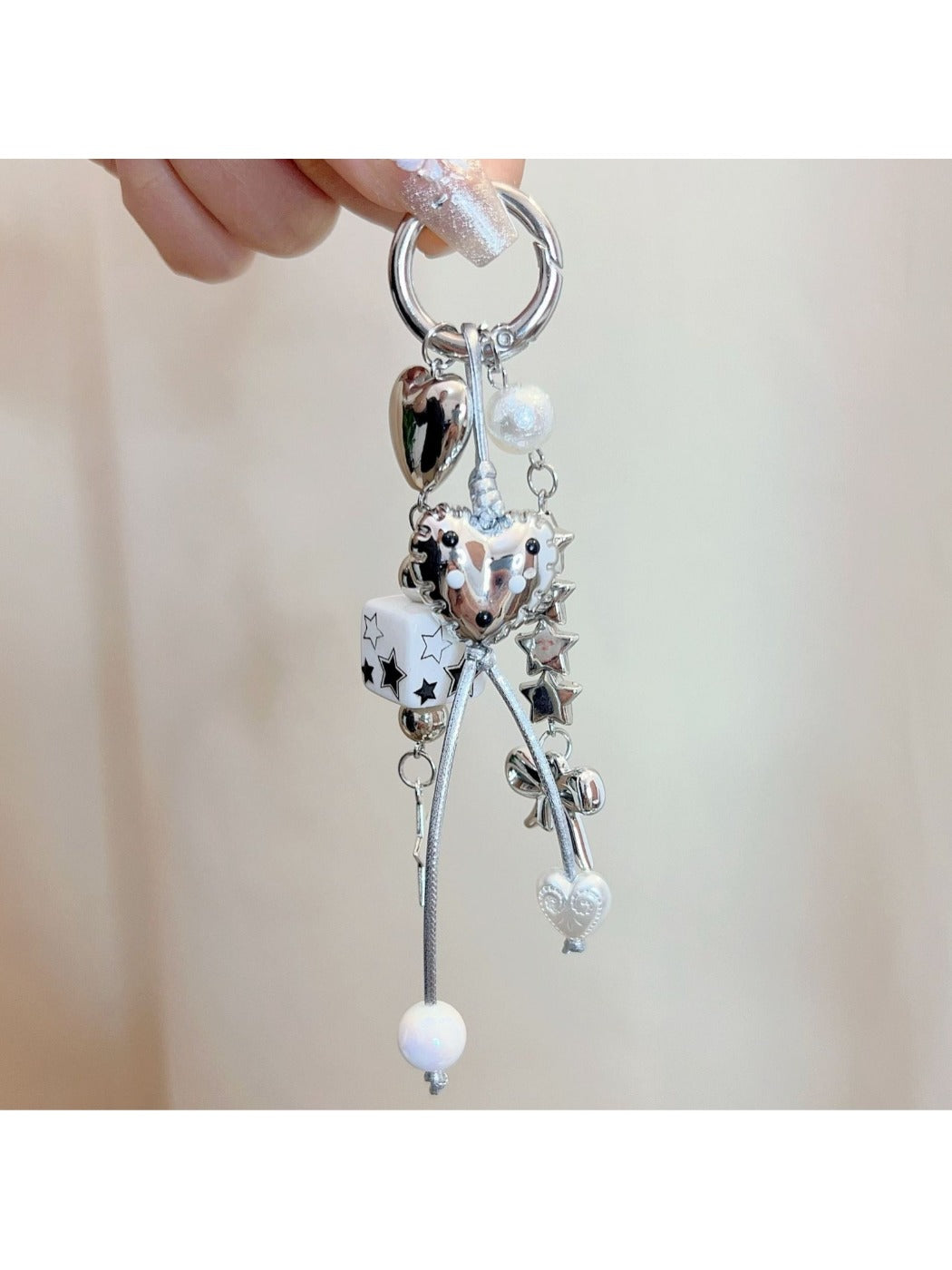 Close-up of Keypus star charm and pink bow on gold keychain