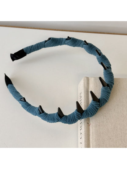 Beige corduroy headband displayed on a white background showing full shape