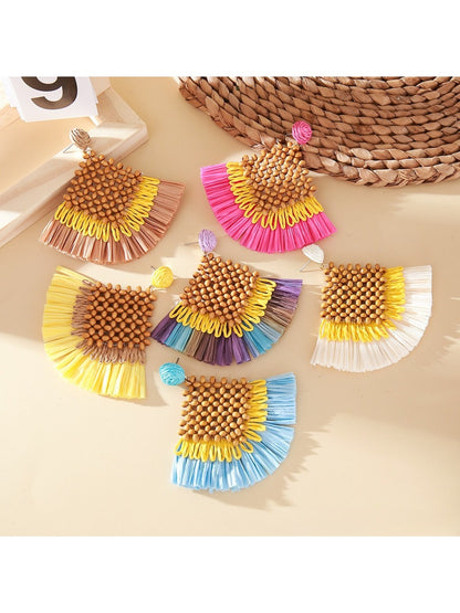 Close-up of vintage square raffia drop earrings with woven texture on white background
