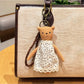Cartoon bear charm keychain held in hand to show size and scale
