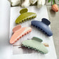 Side view of Beau polka dot acetate claw clip displaying curved shape