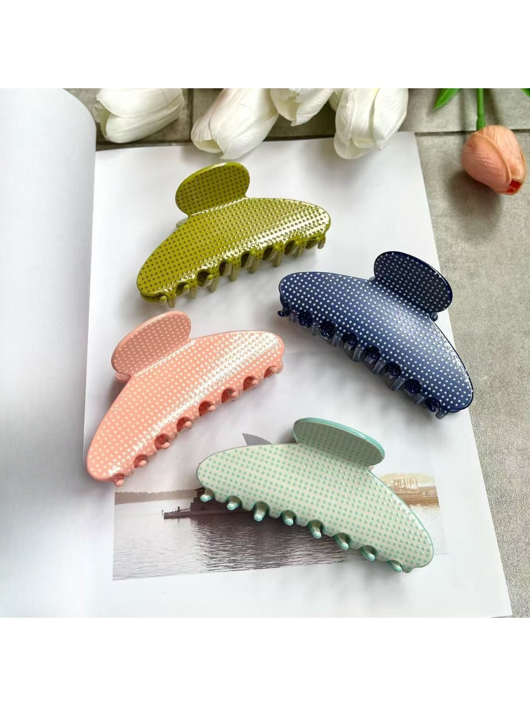 Side view of Beau polka dot acetate claw clip displaying curved shape