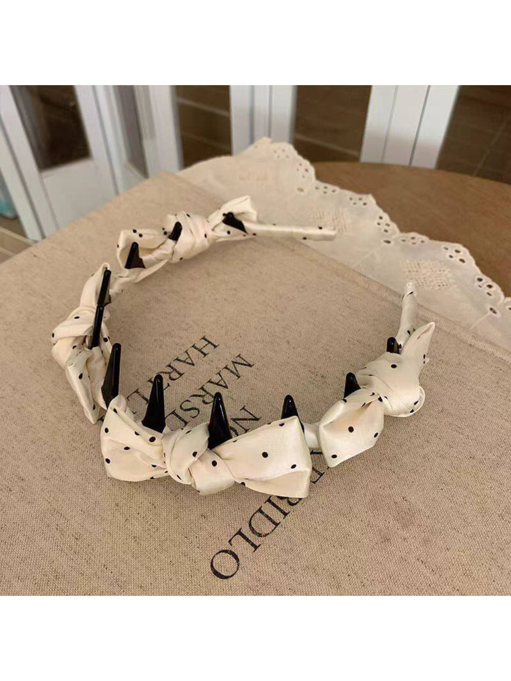 Side view of Gifty satin polka dot bow headband showing bow detail