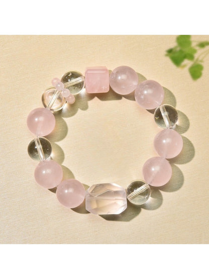 Close-up of Lovra minimalist pink beaded bracelet with gold accent beads on a white background