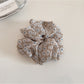 Gifty scrunchie packaged in branded box with clear view of daisy print