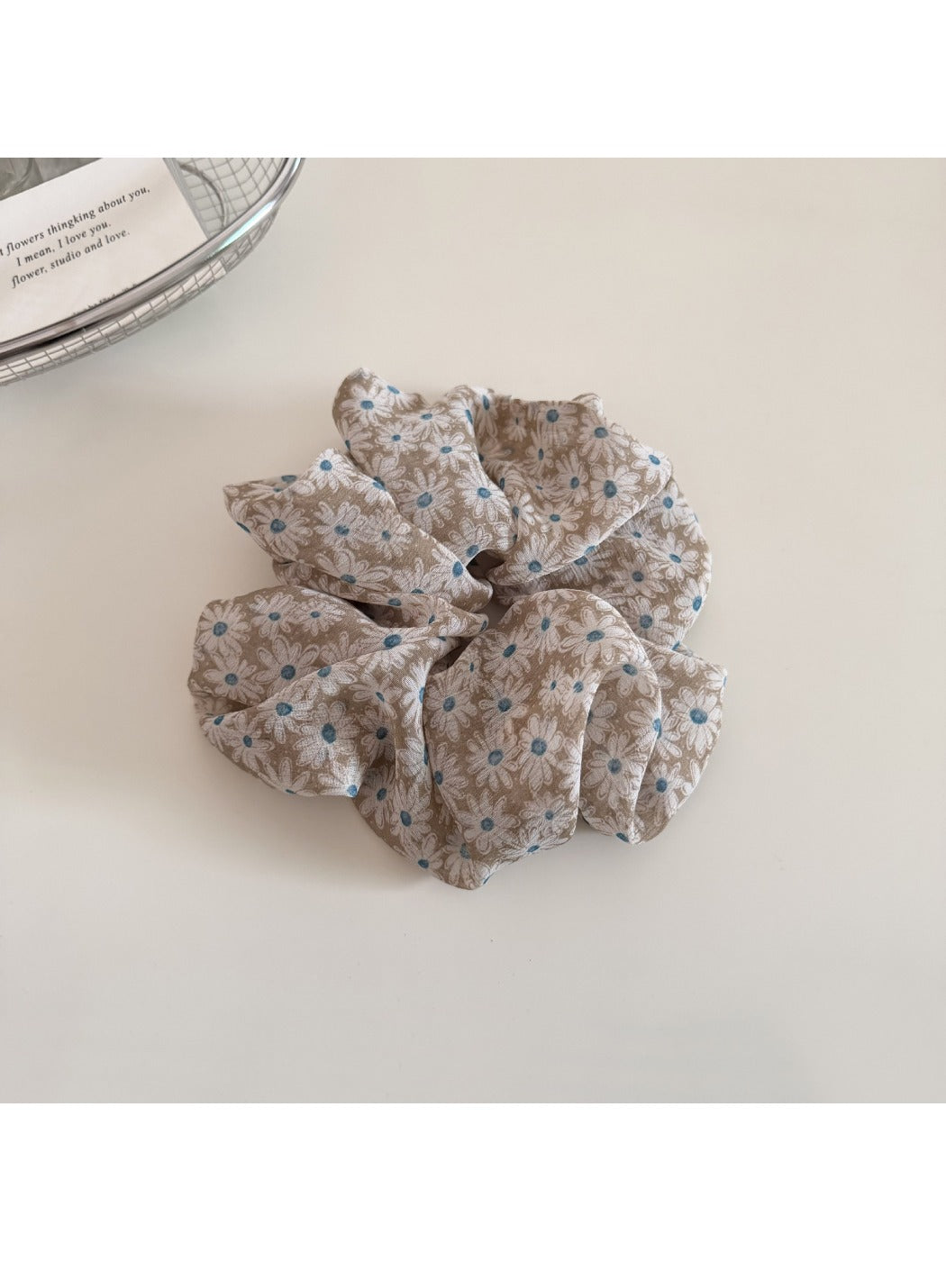 Gifty scrunchie packaged in branded box with clear view of daisy print
