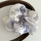 Detailed shot of Gifty satin scrunchie fabric with colorful floral design