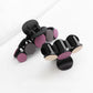 Beau hair clip attached to brown hair styled in loose waves