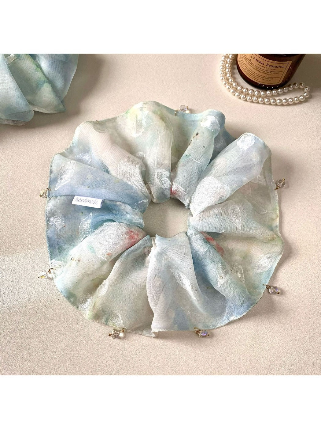 Gifty blue scrunchie displayed on a white background showing its texture