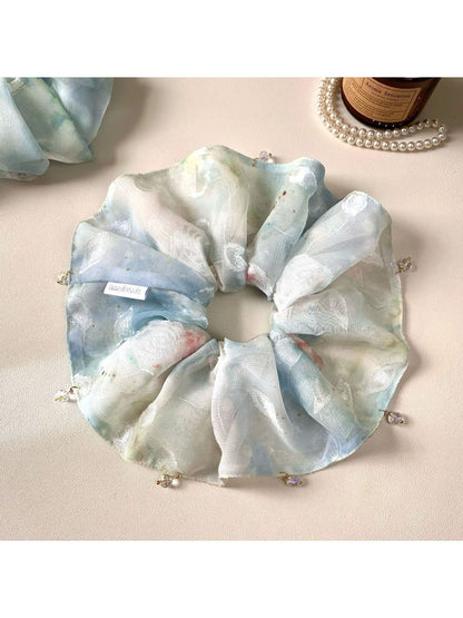 Gifty blue scrunchie displayed on a white background showing its texture